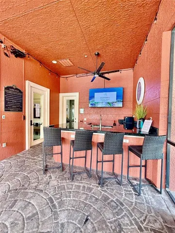 a living room with couches a dining table and chairs with a large window