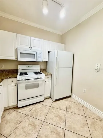 a white refrigerator freezer sitting in a kitchen