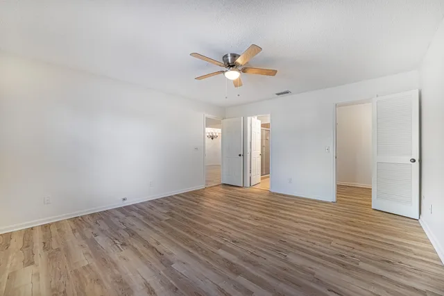 a view of empty room with wooden floor