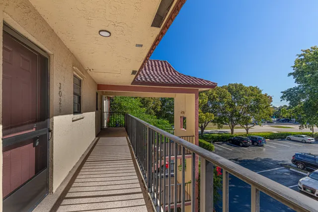 a view of a balcony with car parked