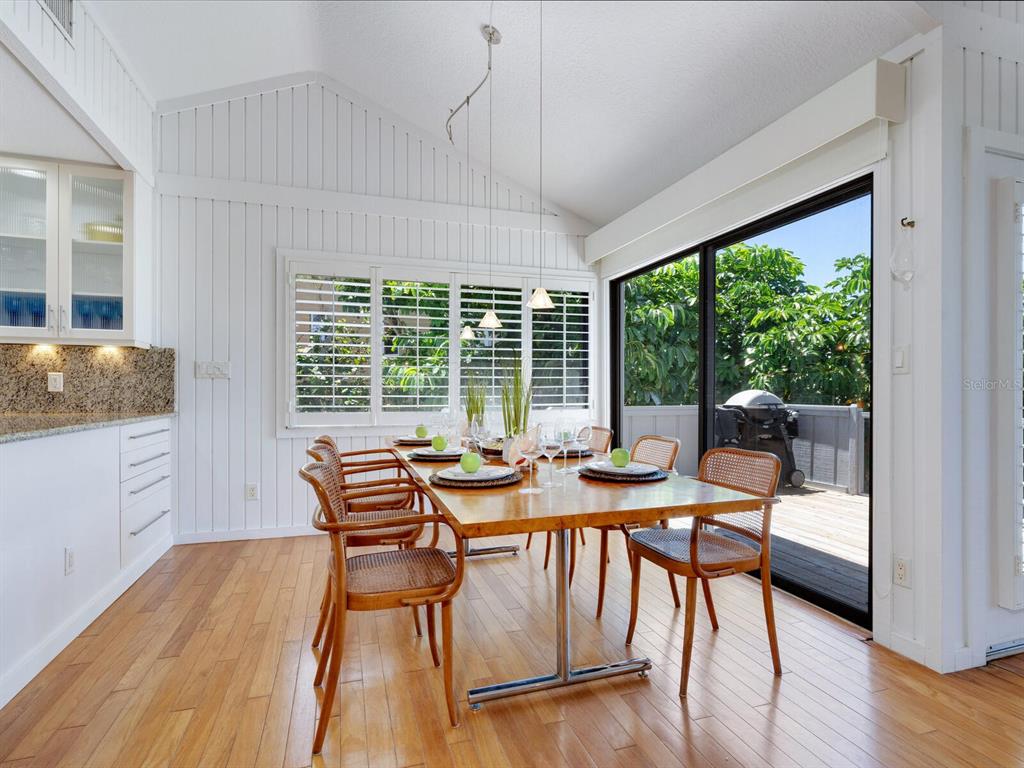 3201 Casey Key Road Nokomis, FL 34275 - Photo 12 of 98 a view of a dining room with furniture window and wooden floor