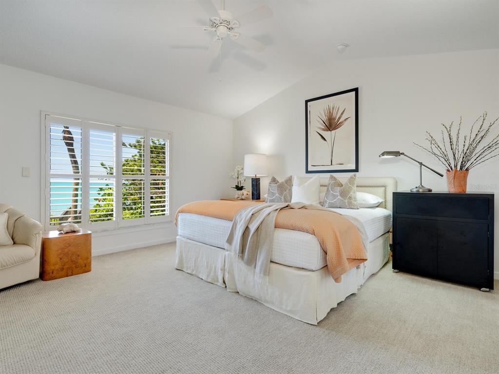3201 Casey Key Road Nokomis, FL 34275 - Photo 16 of 98 a spacious bedroom with a bed and a couch