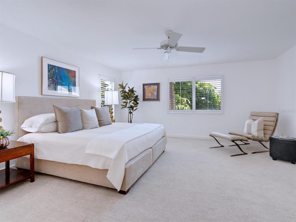 3201 Casey Key Road Nokomis, FL 34275 - Photo 21 of 98 a spacious bedroom with a bed and wooden floor