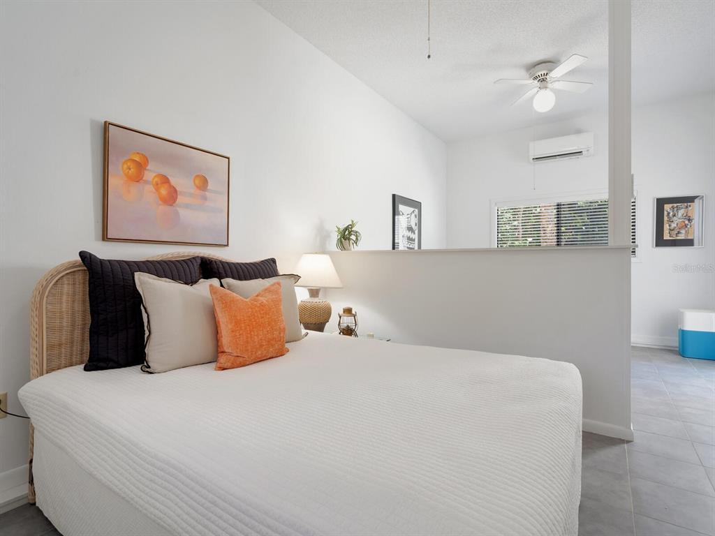 3201 Casey Key Road Nokomis, FL 34275 - Photo 31 of 98 a bedroom with bed and painting on the wall
