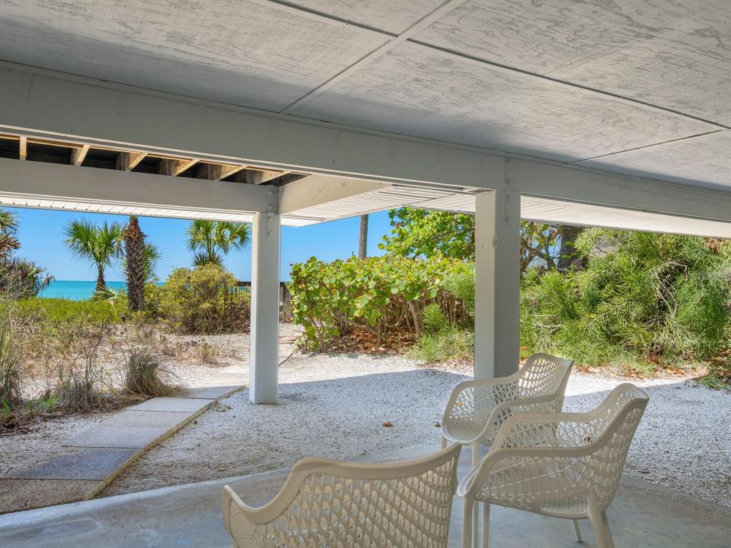 3201 Casey Key Road Nokomis, FL 34275 - Photo 36 of 98 a front view of a house with garden