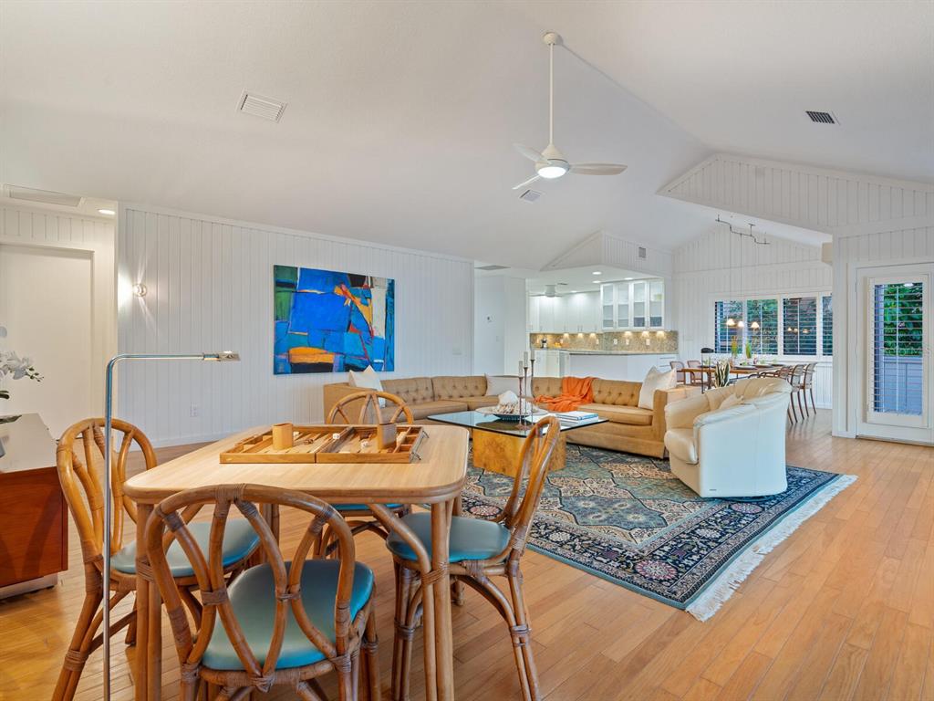 3201 Casey Key Road Nokomis, FL 34275 - Photo 51 of 98 a living room with furniture a rug and kitchen view