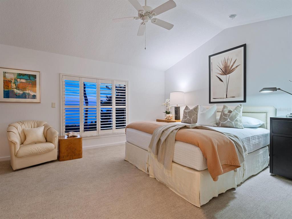 3201 Casey Key Road Nokomis, FL 34275 - Photo 53 of 98 a spacious bedroom with a bed and ceiling fan