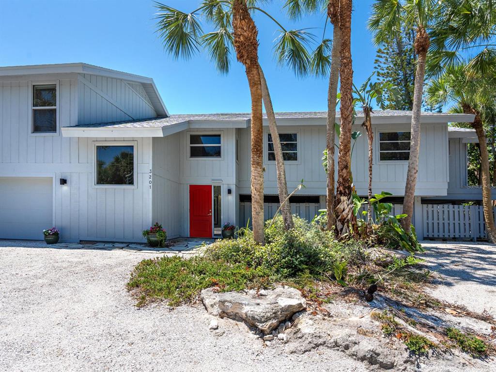 3201 Casey Key Road Nokomis, FL 34275 - Photo 75 of 98 a front view of a house with a yard
