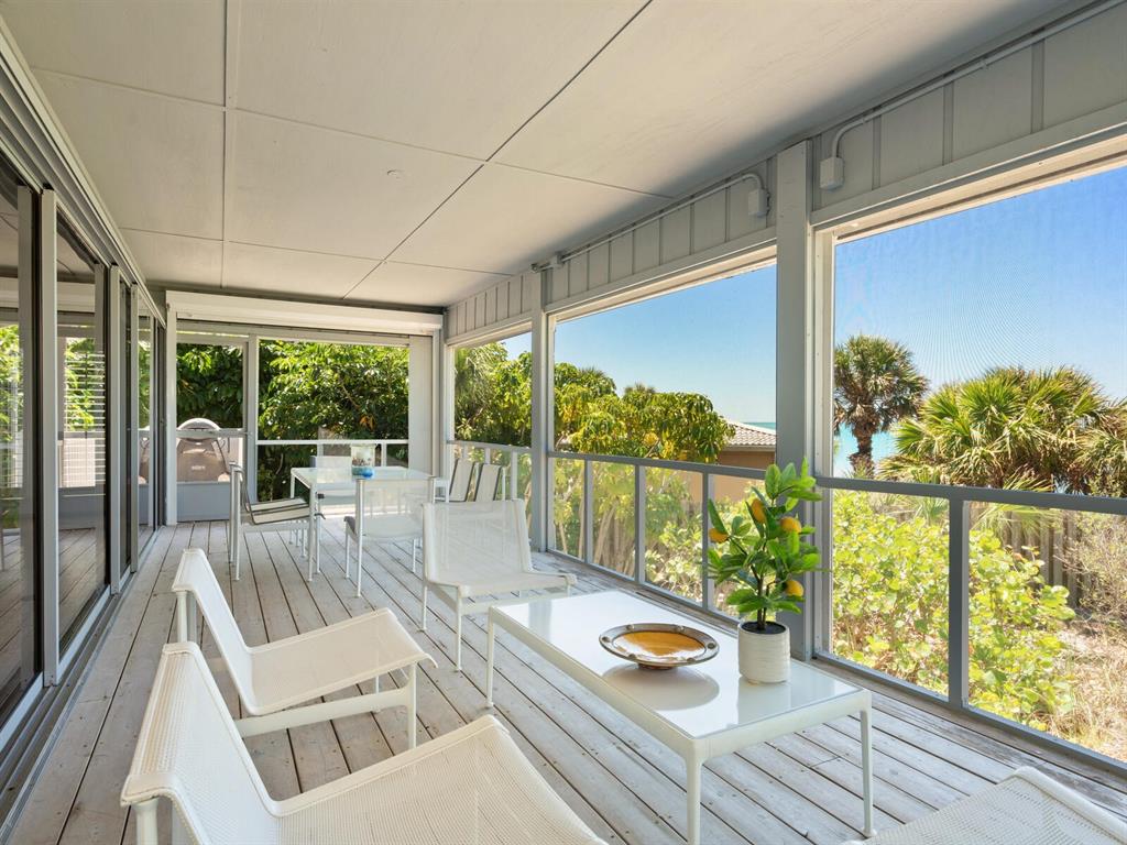 3201 Casey Key Road Nokomis, FL 34275 - Photo 80 of 98 a view of a patio with chairs and wooden floor