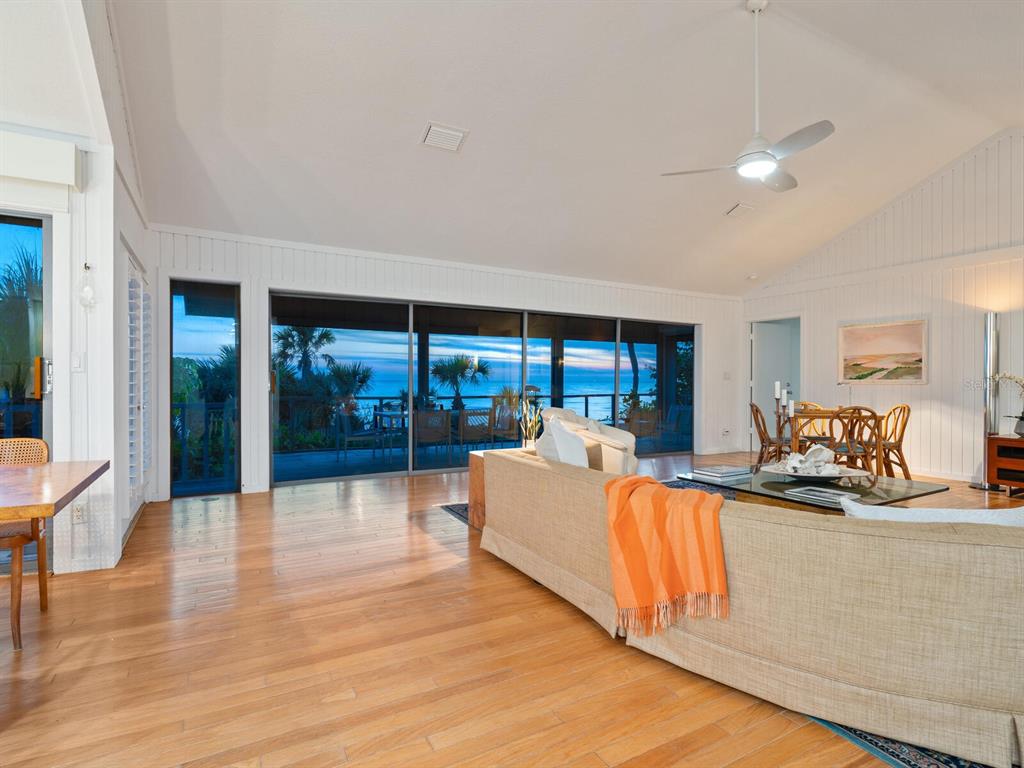 3201 Casey Key Road Nokomis, FL 34275 - Photo 91 of 98 a living room with furniture floor to ceiling window and a flat screen tv