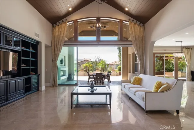 a kitchen with stainless steel appliances a stove a sink island and a refrigerator with wooden cabinets