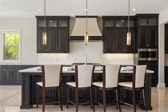 a kitchen with granite countertop stainless steel appliances and refrigerator