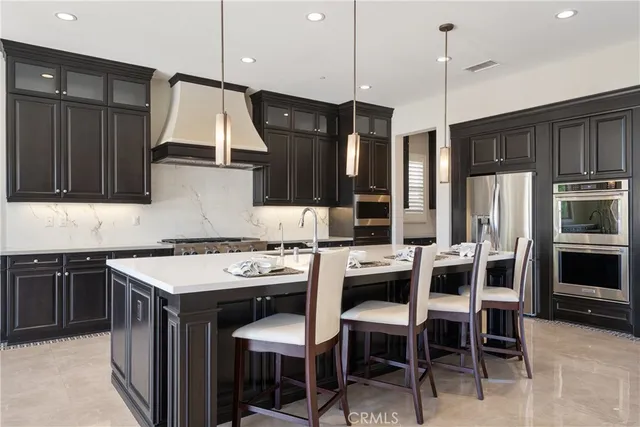 a kitchen with stainless steel appliances granite countertop a refrigerator and a sink