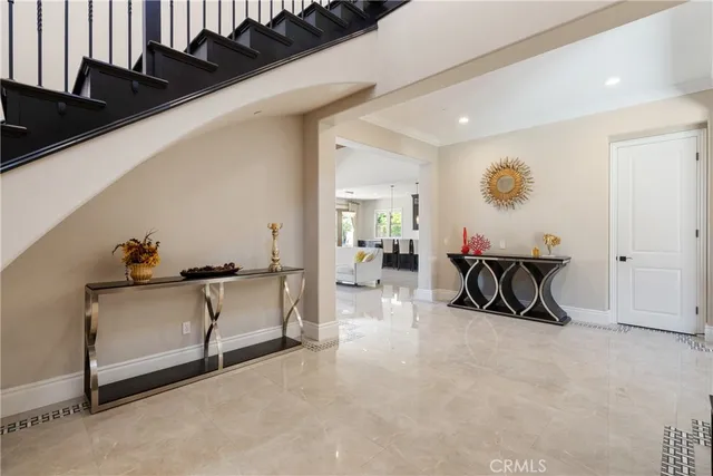 a living room with furniture a floor to ceiling window and a flat screen tv