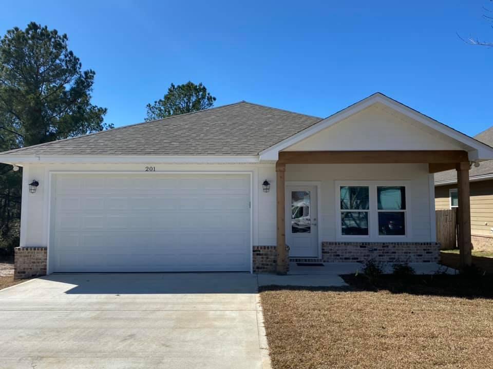 400 Fanny Ann Way Freeport, FL 32439 - Photo 5 of 20 a view of a house with a small yard and potted plants