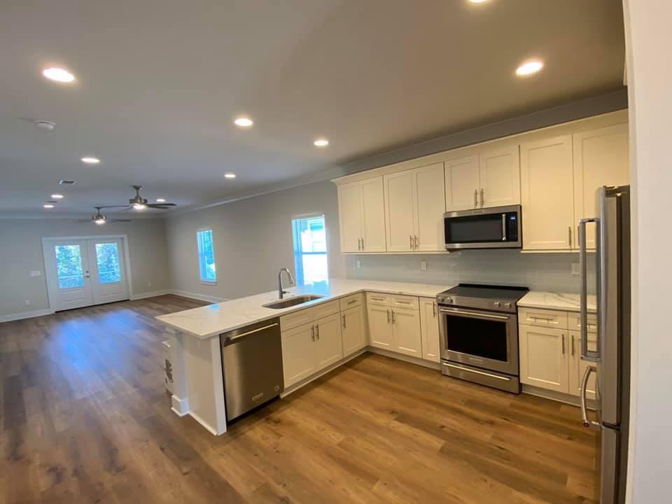 400 Fanny Ann Way Freeport, FL 32439 - Photo 7 of 20 a kitchen with stainless steel appliances granite countertop a stove a sink and a refrigerator