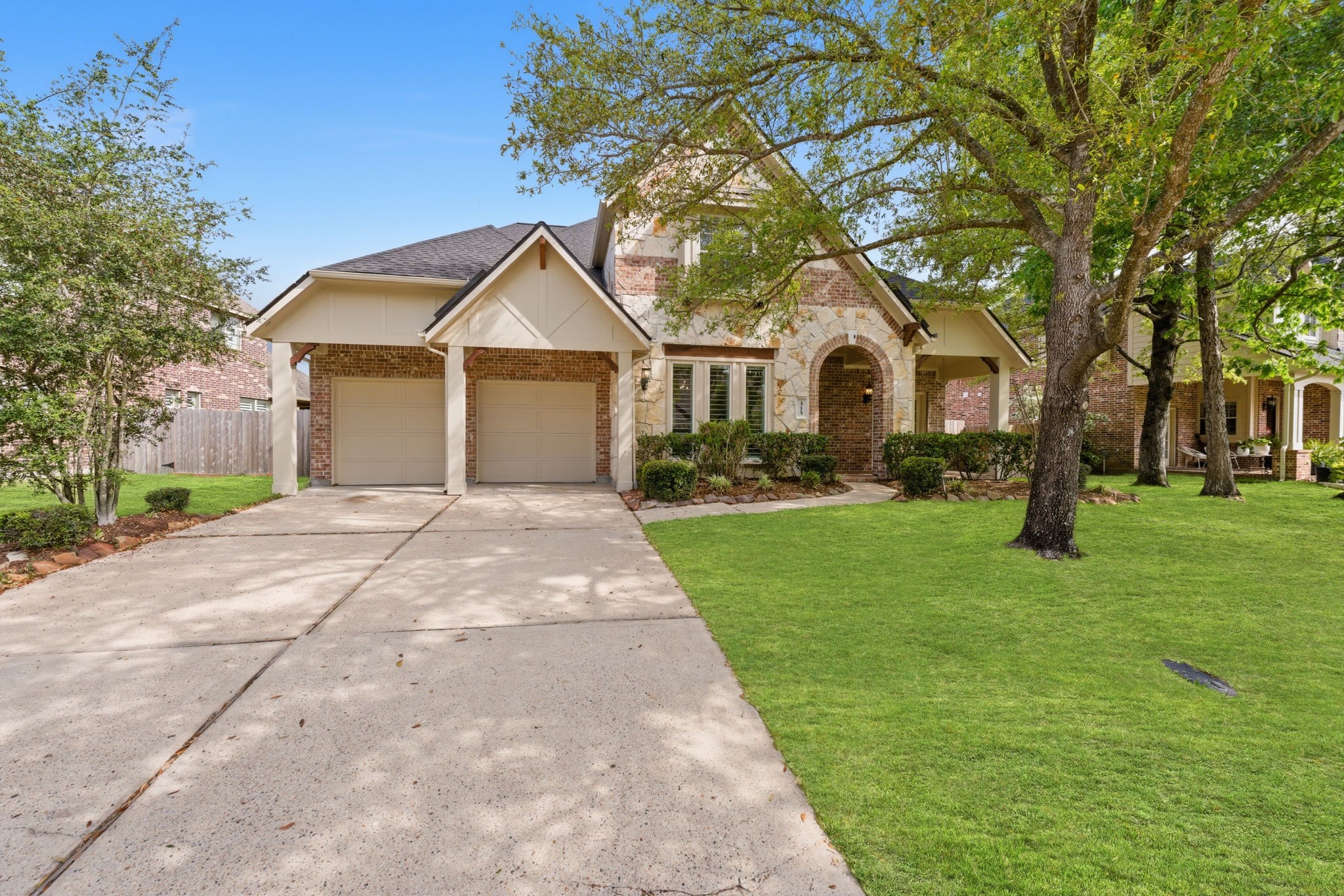 315 Arbor Ridge Lane Conroe, TX 77384 - Photo 48 of 48 a front view of a house with a garden and trees