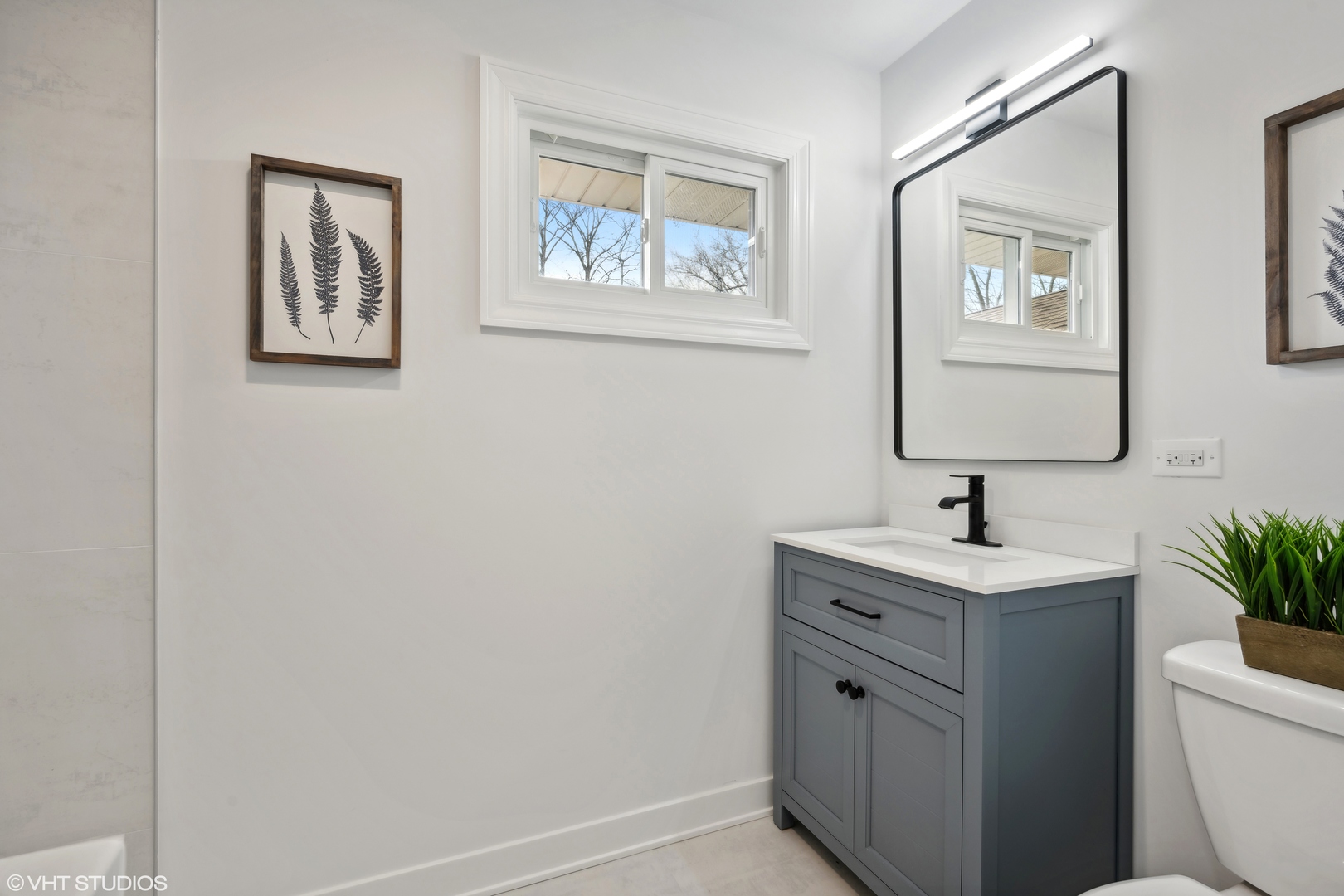 26340 West Merton Road Barrington, IL 60010 - Photo 14 of 22 a bathroom with a toilet sink and mirror