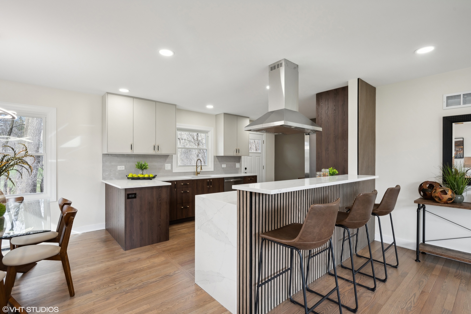 26340 West Merton Road Barrington, IL 60010 - Photo 5 of 22 a kitchen with stainless steel appliances a dining table chairs stove refrigerator and cabinets