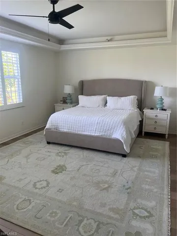 a spacious bedroom with a bed and window