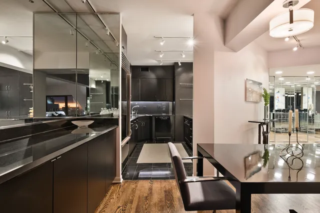 a kitchen with stainless steel appliances kitchen island granite countertop a sink and cabinets