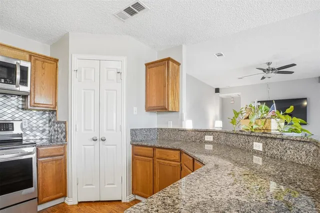 a spacious bedroom with a bed a chandelier and a large window