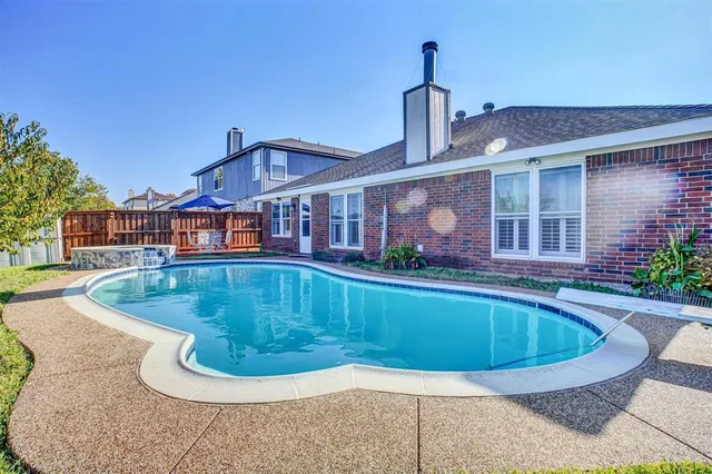 a view of a backyard with swimming pool