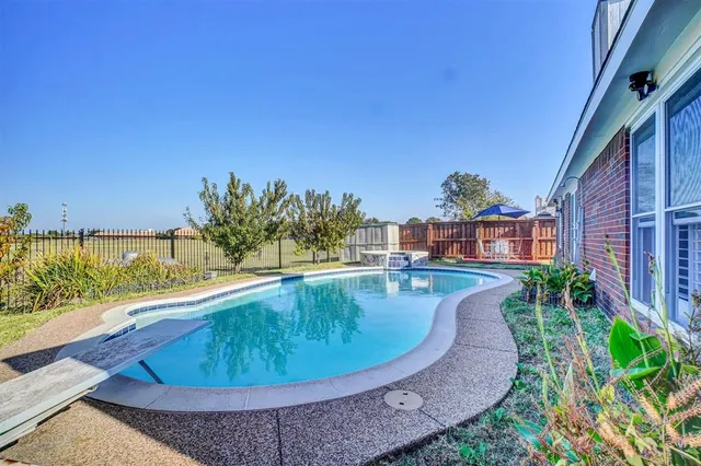 a view of a house with a yard potted plants and large tree