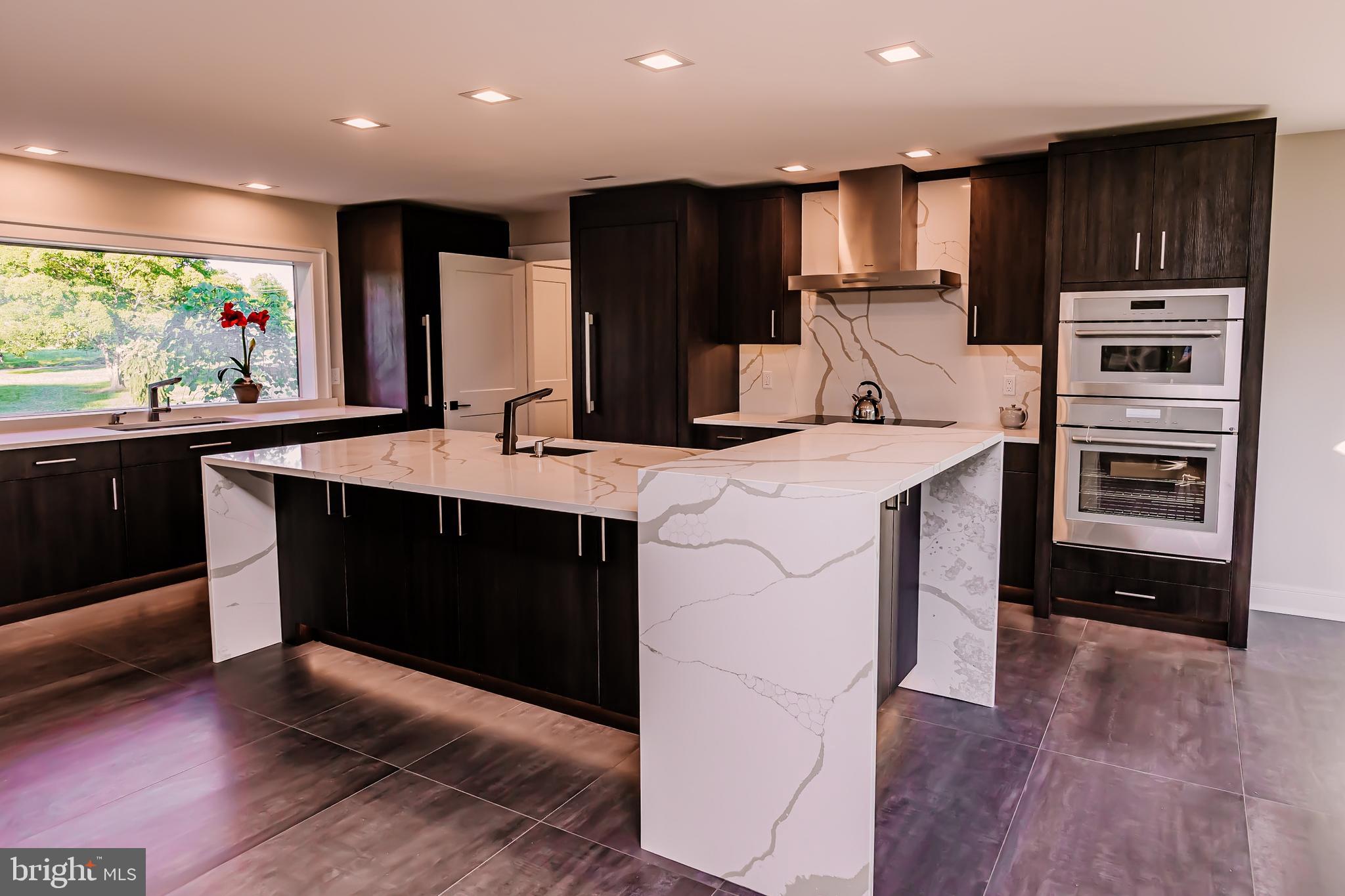 1091 Highland Road Newtown, PA 18940 - Photo 33 of 128 a kitchen with stainless steel appliances kitchen island granite countertop a stove a sink and a refrigerator