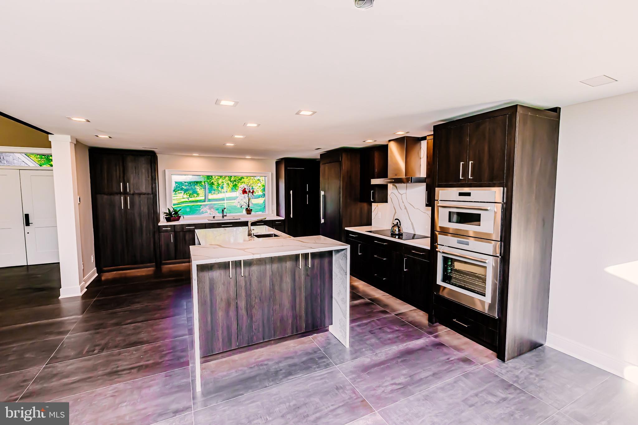 1091 Highland Road Newtown, PA 18940 - Photo 43 of 128 a kitchen with kitchen island wooden cabinets and stainless steel appliances