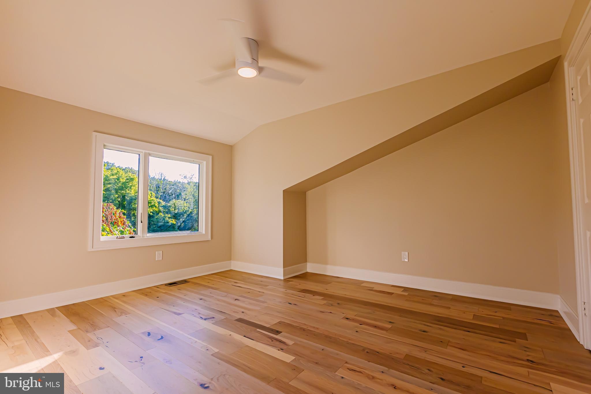 1091 Highland Road Newtown, PA 18940 - Photo 90 of 128 a view of an empty room with wooden floor and a window