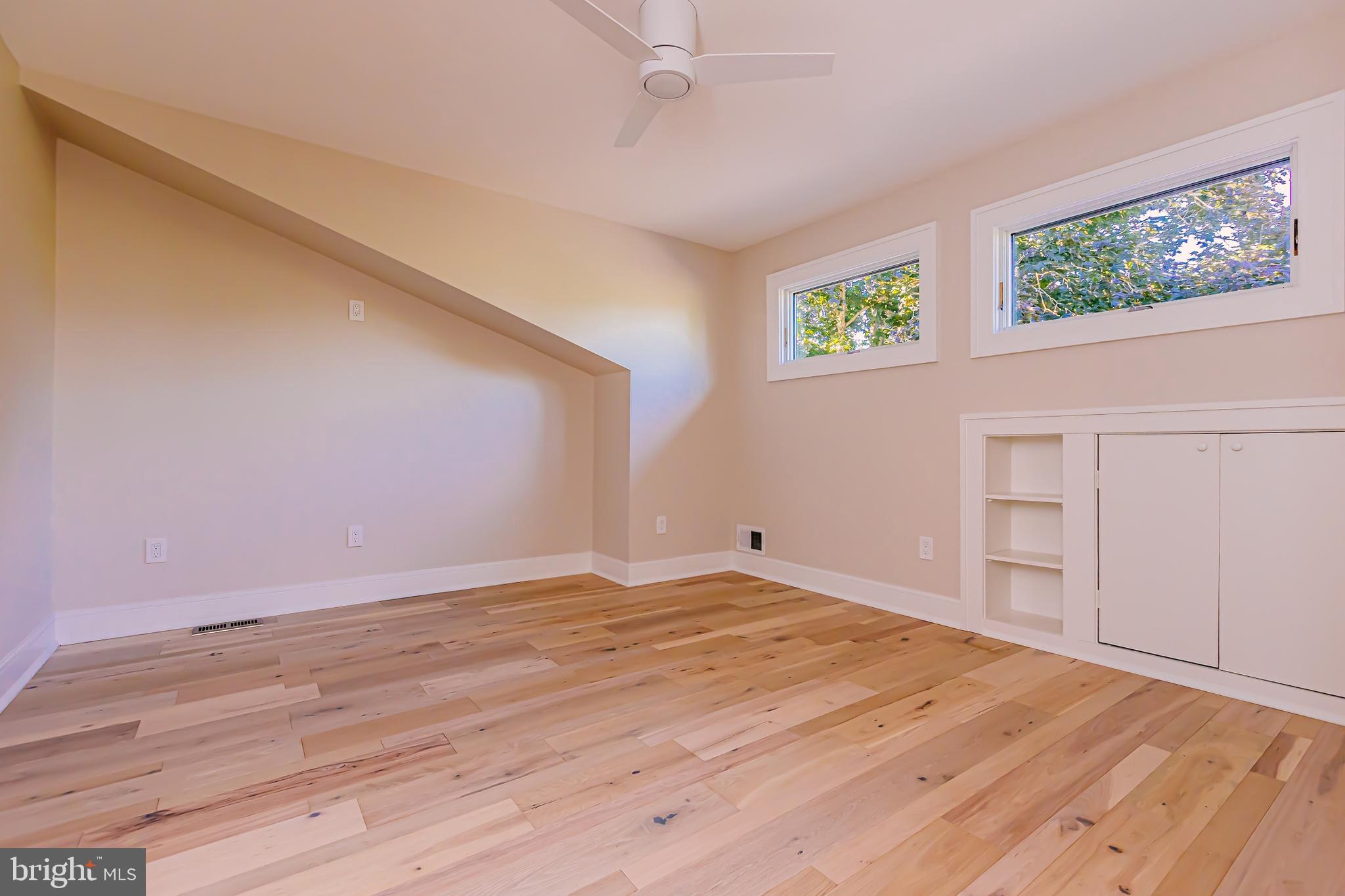 1091 Highland Road Newtown, PA 18940 - Photo 92 of 128 a view of an empty room with a window and wooden floor