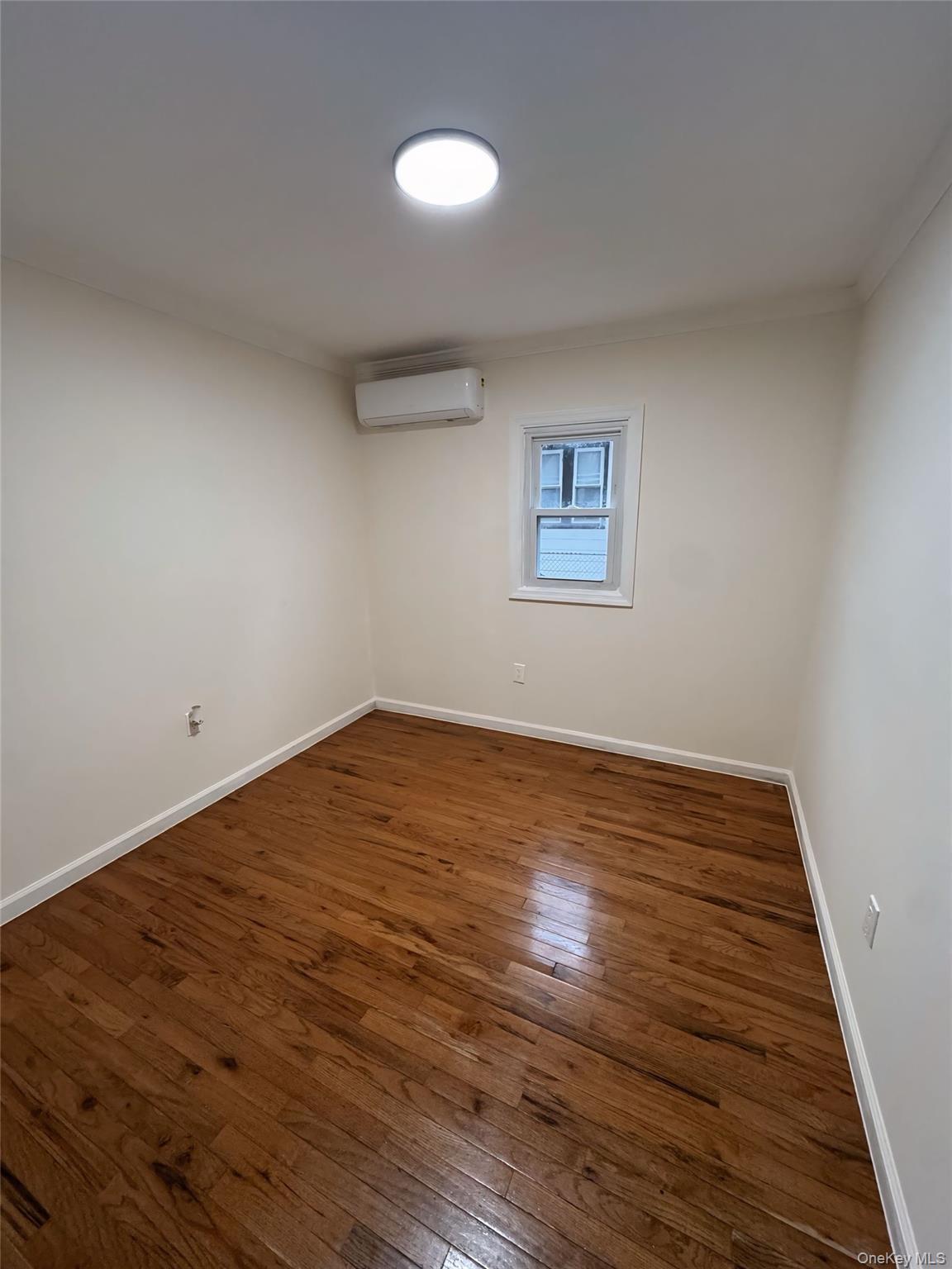 177-16 Leslie Road, Unit 2 Queens, NY 11434 - Photo 4 of 6 a view of empty room with wooden floor