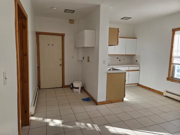 a view of a room with wooden floor and a window