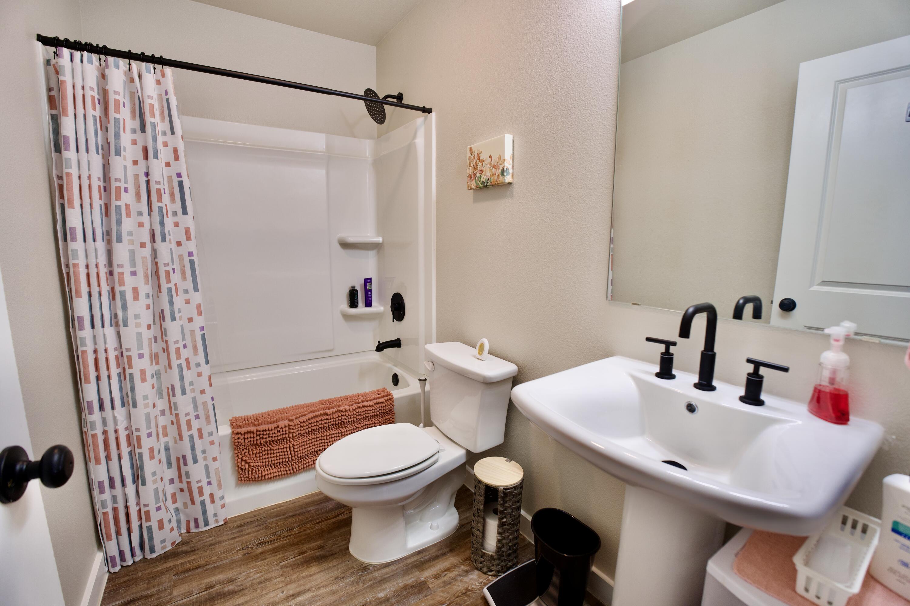 1913 134th Street Lubbock, TX 79423 - Photo 11 of 15 a bathroom with a sink toilet and shower