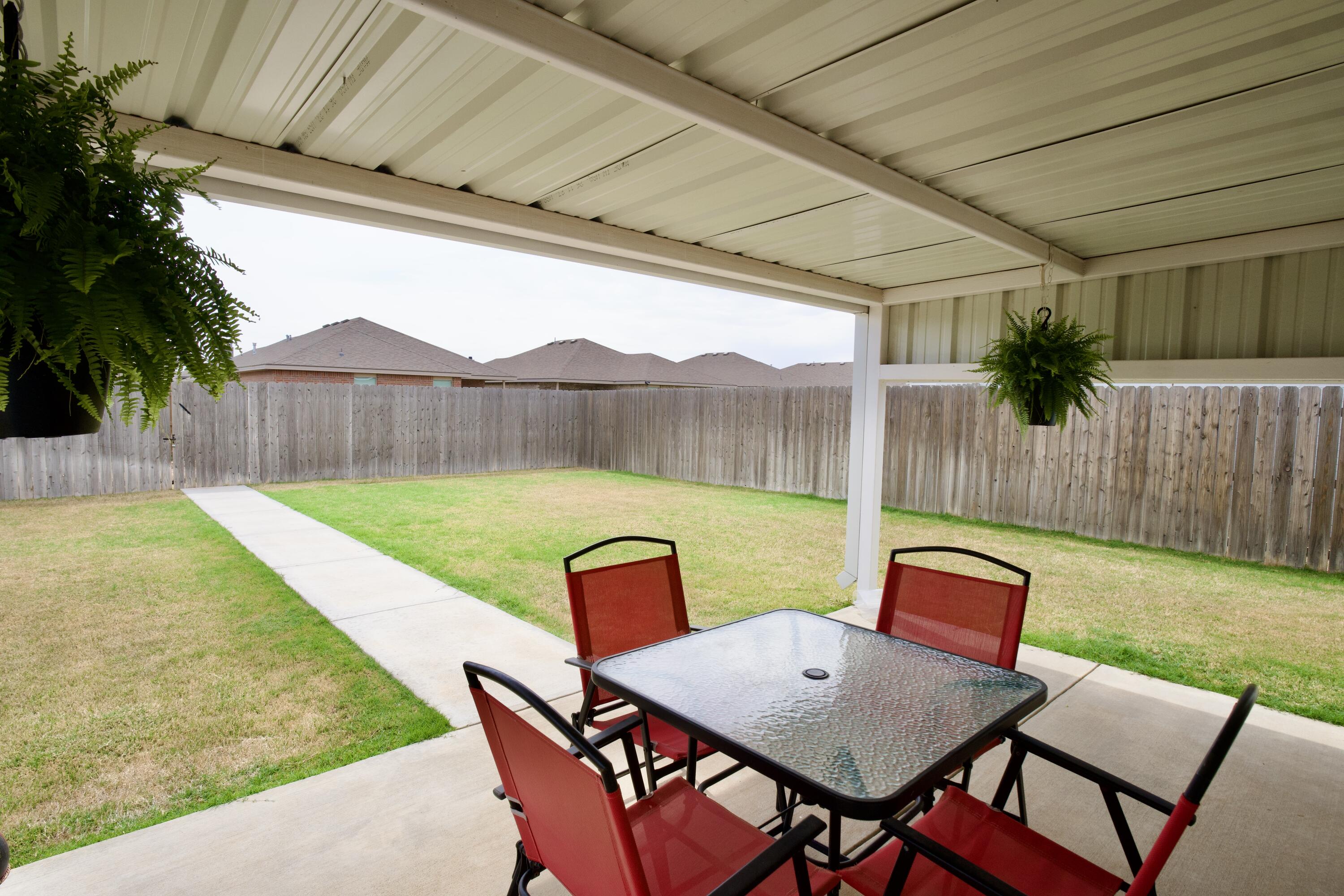 1913 134th Street Lubbock, TX 79423 - Photo 15 of 15 a backyard of a house with table and chairs