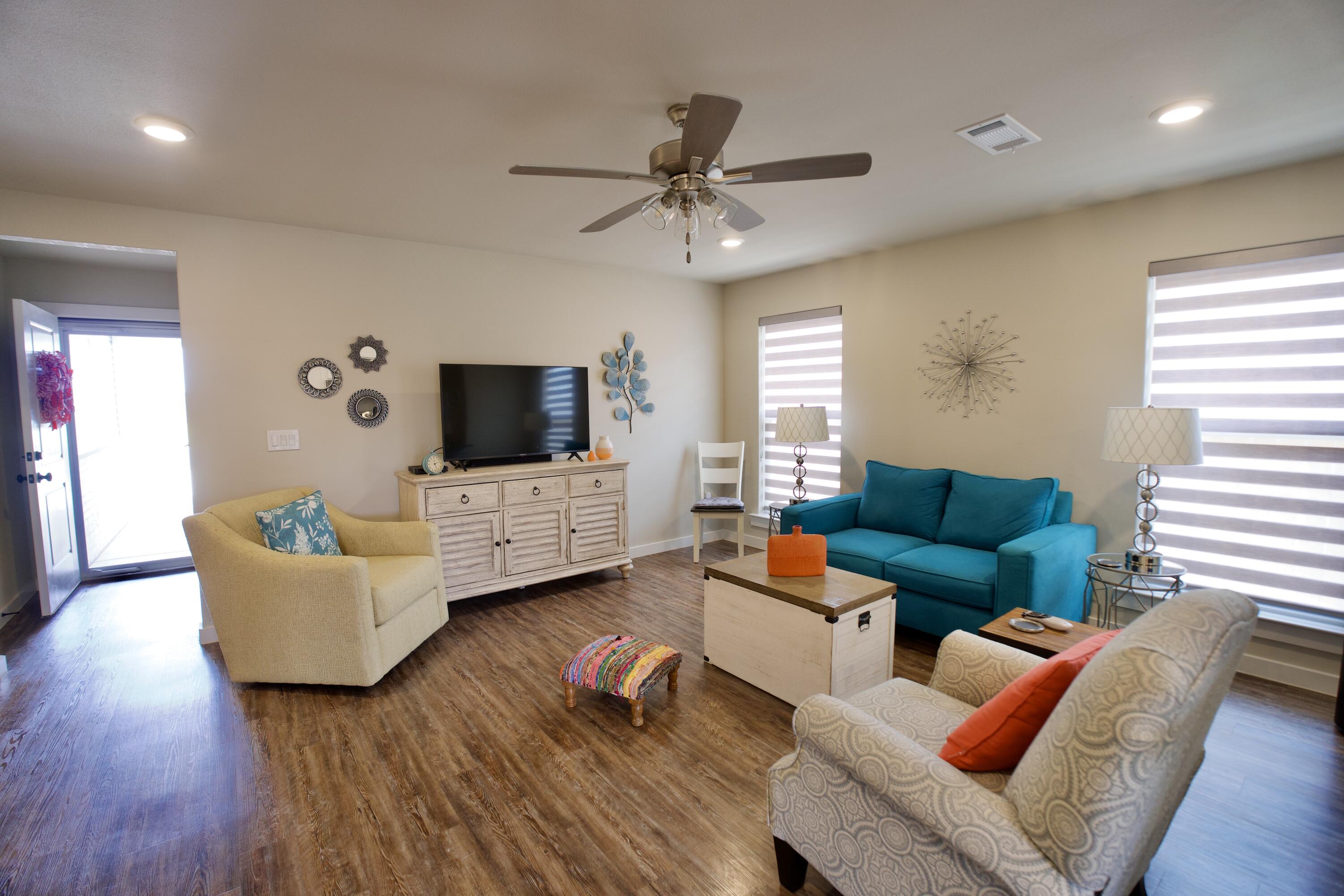 1913 134th Street Lubbock, TX 79423 - Photo 2 of 15 a living room with furniture and a flat screen tv