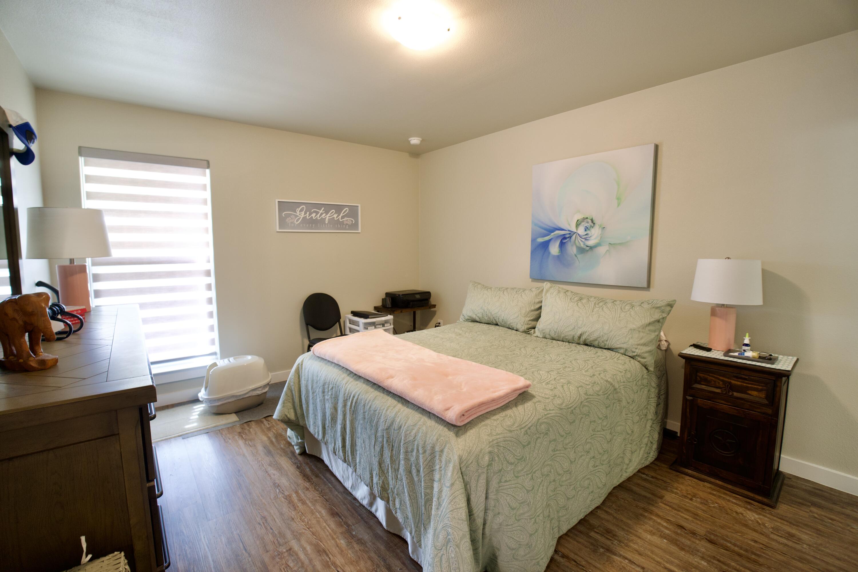 1913 134th Street Lubbock, TX 79423 - Photo 8 of 15 a bedroom with a bed and wooden floor