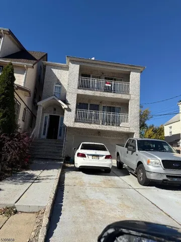 a bathroom with a granite countertop sink a toilet and a mirror