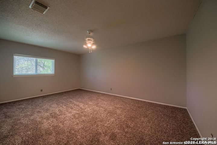6911 Ridge Pl Street San Antonio, TX 78250 - Photo 19 of 22 an empty room with a window