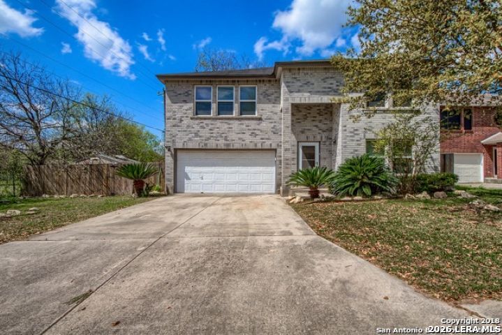 6911 Ridge Pl Street San Antonio, TX 78250 - Photo 2 of 22 a front view of a house with a yard