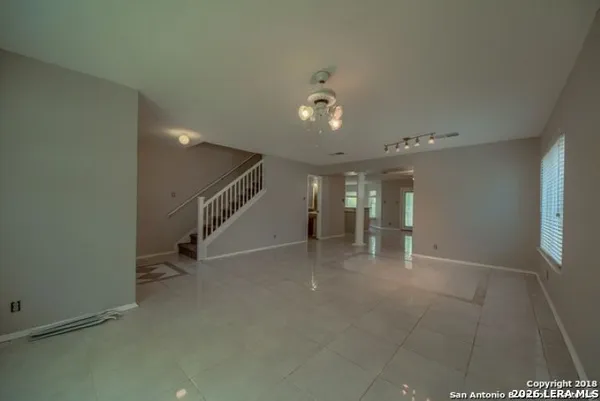 a view of an empty room with stairs