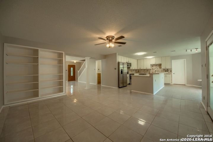 6911 Ridge Pl Street San Antonio, TX 78250 - Photo 10 of 22 a view of a livingroom with a refrigerator a kitchen a sink dishwasher and a refrigerator