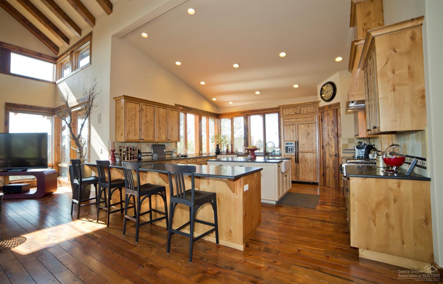16448 South W Brasada Ranch Road Powell Butte, OR 97753 - Photo 6 of 25 a kitchen with lots of counter top space and painting on the wall