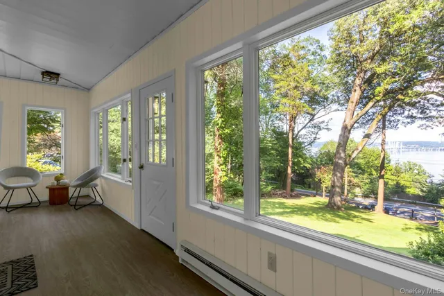a living room with furniture and large windows