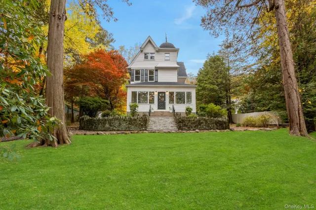 a front view of a house with a garden