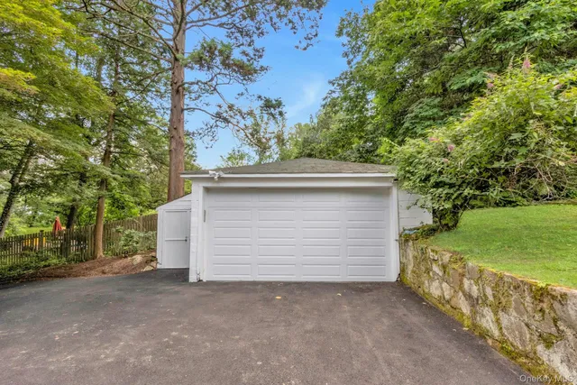 a small yard with a table and chair under an umbrella