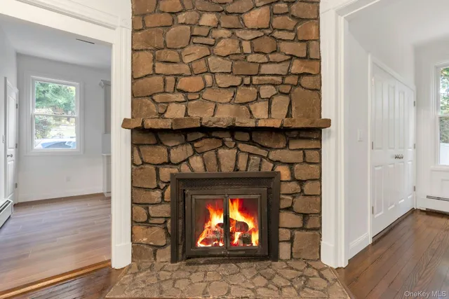 a room with a fireplace and wooden floor