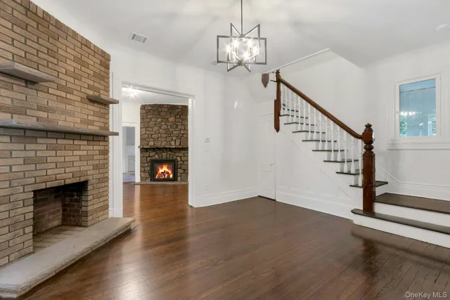 a view of a livingroom with wooden floor and fireplace