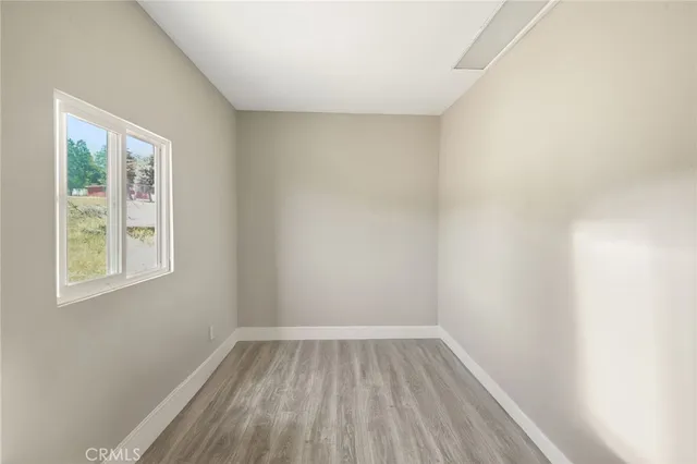 a view of room with window and hardwood floor